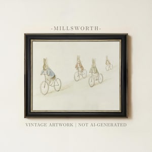 May include: A framed illustration titled MILLSWORTH featuring four rabbits riding bicycles in a line. The artwork uses soft watercolor tones of brown, blue, and green on a light background. The frame is black with a thin gold inner border.