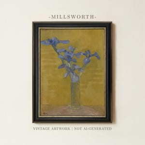 May include: A framed oil painting titled MILLSWORTH featuring a bouquet of blue irises in a glass vase against a mustard yellow background. The artwork is enclosed in a black frame with a thin silver inner border, presented as vintage artwork.