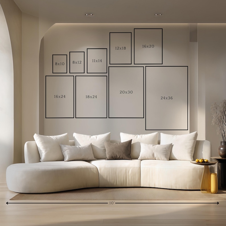May include: A modern living room featuring a large, curved cream-colored sofa with multiple throw pillows. Above the sofa, a collection of framed art prints in various sizes, including 8x10, 8x12, 11x14, 12x18, 16x20, 16x24, 18x24, 20x30, and 24x36 inches.