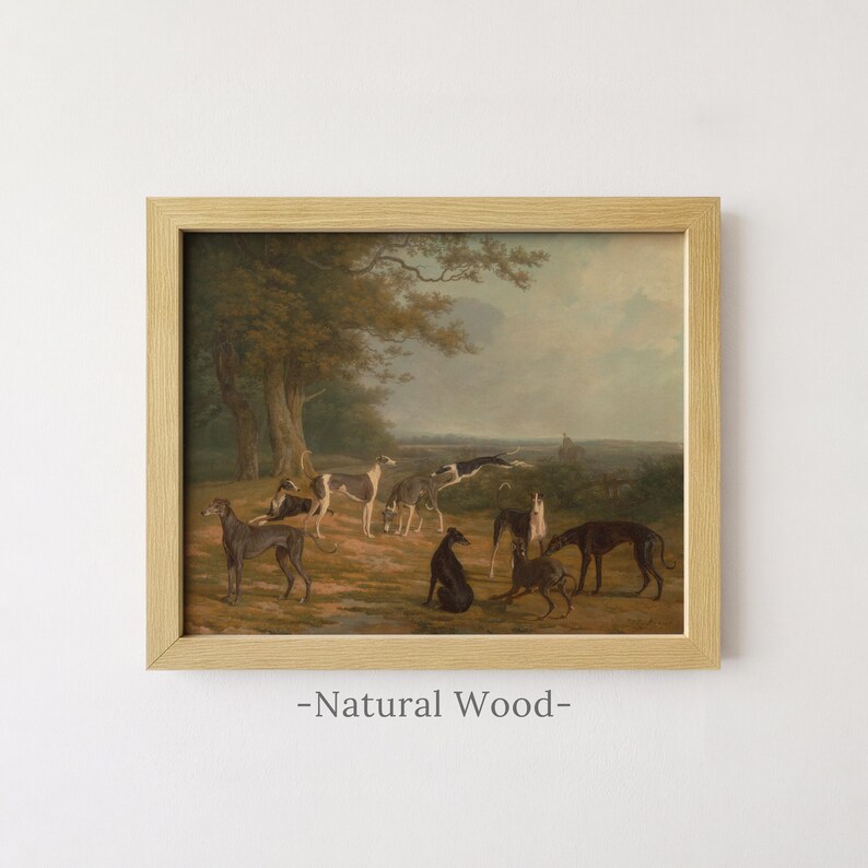 May include: A framed landscape painting featuring a group of greyhounds in a field with trees under a cloudy sky. The artwork is enclosed in a light-coloured natural wood frame. The text -Natural Wood- is printed below the framed artwork.