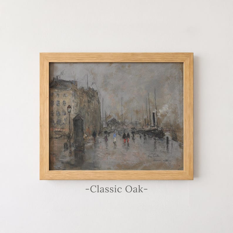 May include: A framed oil painting in a light-toned oak frame depicting a rainy harbor scene with muted gray and brown tones. The artwork shows buildings, ships, and small figures walking along a wet quay, with the text Classic Oak below.