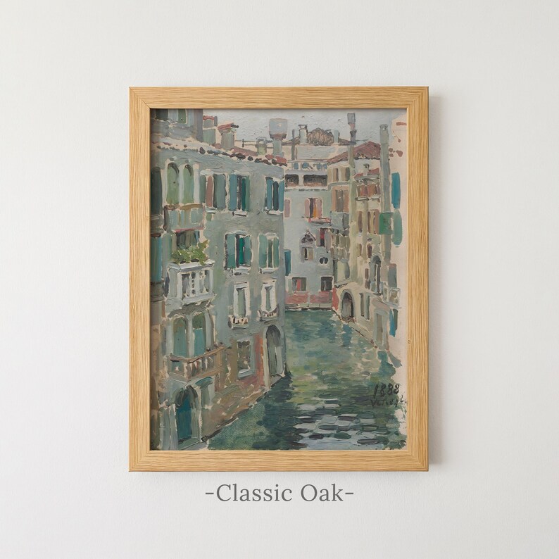 May include: An oil painting of a Venetian canal scene with multi-story buildings in shades of gray, blue, and tan, framed in a light-colored wood frame. The painting features the text 1888 in the lower right corner and Classic Oak below.