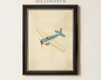 May include: A framed wall art print featuring a blue and cream-colored vintage airplane illustration on a beige background. The text MILLSWORTH is printed in black above the image. The artwork is enclosed in a black frame with gold trim.