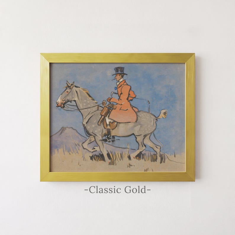 May include: A framed print featuring a painting of a rider in a top hat and orange coat on a dappled gray horse against a blue sky and tan landscape. The artwork is enclosed in a classic gold frame with the text -Classic Gold- printed below.