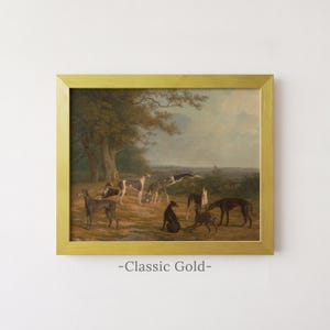 May include: A framed oil painting in a classic gold frame depicting a landscape scene with several greyhound dogs standing and resting on a grassy field near trees. The text "-Classic Gold-" is printed in grey below the framed artwork.