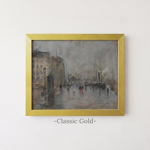May include: A framed painting in a classic gold frame depicting a rainy harbor scene with buildings, ships, and figures walking along a wet quay. The artwork features muted gray and brown tones with small pops of color and the text Classic Gold.