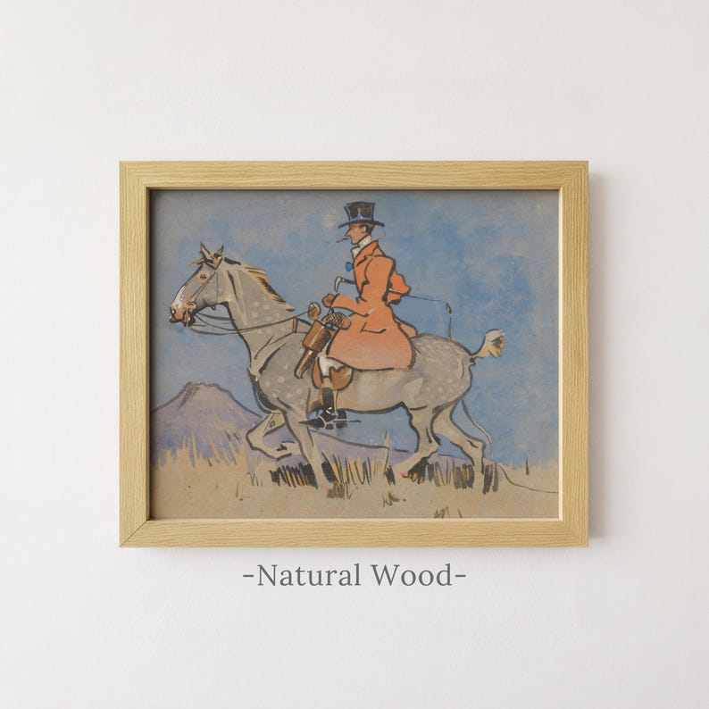 May include: A framed print in a natural wood frame featuring an illustration of a rider in a top hat and orange coat mounted on a grey dappled horse. The scene is set against a blue sky and a landscape with a mountain and dry grass.