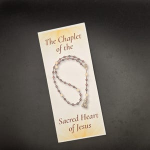 May include: A set of three ceramic mugs with a speckled, matte finish. The mugs are in shades of cream, light gray, and dark gray. Each mug has a simple, minimalist design, perfect for coffee or tea.