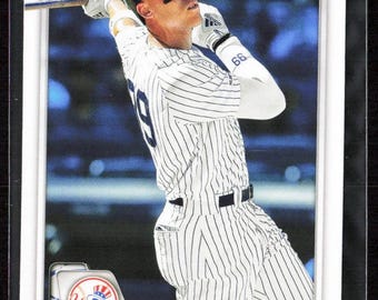 May include: A baseball card featuring Aaron Judge of the New York Yankees in a pinstripe uniform, mid-swing. The card has a white border and the Yankees logo. The Bowman logo is visible in the upper right corner.
