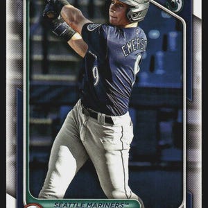 May include: Baseball card featuring Colt Emerson of the Seattle Mariners in a batting stance. The card has a dark blue and green border with the team logo and player's name. The player is wearing a navy blue jersey with the number 9.