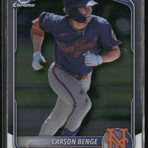 May include: A white ceramic mug with a black handle and the text "But First, Coffee" in a black, handwritten-style font. The mug is on a white surface.