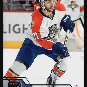 May include: A hockey trading card featuring Vincent Trocheck in a white, red, and blue Florida Panthers jersey with the number 21. The player wears a white helmet, blue gloves, and holds a hockey stick. The card includes the Upper Deck logo.