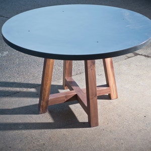 Round table with walnut legs and metal top