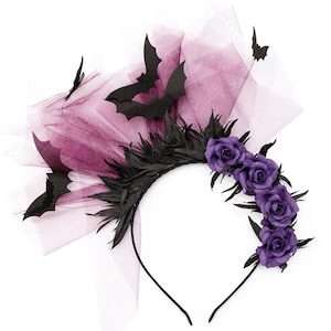 May include: A black headband with a Halloween theme. The headband features black paper bats, black feathers, and purple roses. A sheer purple fabric is attached to the headband.