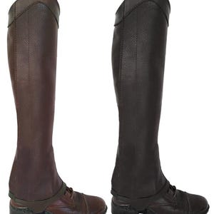 May include: Two tall, leather riding boots in shades of brown and dark brown. The boots have a classic design with a high shaft, a reinforced toe, and a strap across the ankle. The boots are designed for equestrian activities.