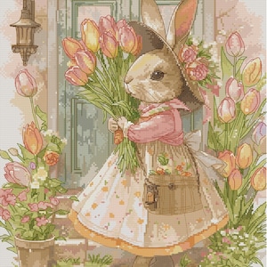 May include: A cross-stitch design of a rabbit in a hat and dress, holding a bouquet of pink and yellow tulips. The rabbit stands before a door, surrounded by flowers and greenery, with a lantern on the side.