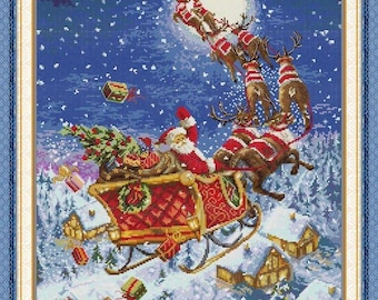 May include: A cross-stitch image of Santa Claus in a red sleigh pulled by reindeer against a snowy night sky. The sleigh is laden with gifts and a Christmas tree. Houses with snow-covered roofs are visible below.