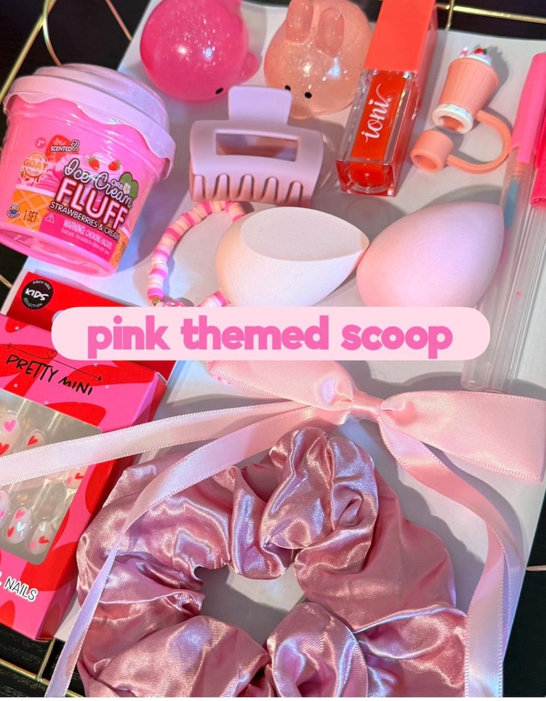 May include: A collection of pink-themed items, including a container of Ice Cream Fluff, a hair clip, a scrunchie, makeup, and a nail kit. The image has the text "pink themed scoop".