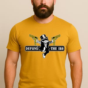 May include: Mustard yellow t-shirt featuring a cartoon character in a tuxedo and top hat, holding two gold-colored pistols. The text "DEFUND THE IRS" is printed above the character. The shirt is made of a soft material.