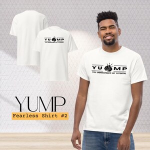 May include: White t-shirt featuring the text "YUMP" and "You Underestimate My Potential" in black, with a fist graphic. The shirt is part of the "Fearless Shirt #2" collection.