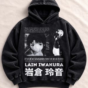 Può includere: Una felpa con cappuccio nera lavata all'acido con una stampa grafica di un personaggio anime. Il testo recita: People only have substance within the memories of other people, IF YOU'RE NOT REMEMBERED, THEN YOU NEVER EXISTED, LAIN IWAKURA.