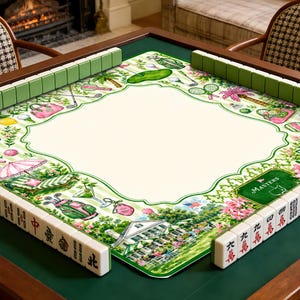 May include: A square mahjong mat featuring a cream-colored center with a green border decorated with golf-themed illustrations, including golf bags, clubs, and a clubhouse. The mat is surrounded by green mahjong tiles with black characters.