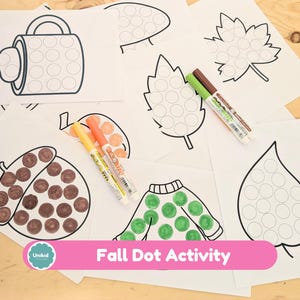 May include: Fall-themed dot activity sheets with outlines of a mug, leaves, an acorn, and a sweater. Two markers are visible, one green and brown, and the other orange and yellow. The text "Fall Dot Activity" is displayed on a pink banner.