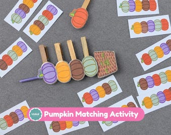 May include: A pumpkin matching activity set featuring wooden clothespins with attached colorful pumpkin cutouts and a woven basket cutout. Several rectangular cards display sequences of purple, orange, brown, and light green pumpkins.