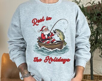 Santa Fishing Christmas Sweatshirt, Reel in the Holidays Fishing Shirt, Holiday Bass Fisherman Gift