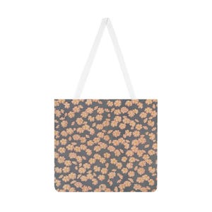 May include: A tote bag with a floral pattern. The bag features a dark gray background covered in small, peach-colored flowers. It has white straps for carrying. The bag is designed for carrying items.