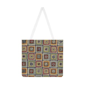 May include: A white tote bag with a colorful, patterned design. The pattern features squares with floral and geometric motifs in red, yellow, green, and blue. The bag has white straps.