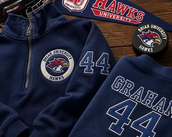May include: Navy blue quarter-zip sweatshirt and matching crewneck sweatshirt with the text "Briar University Hawks" and the number "44". A hockey helmet, pennant, and hockey puck with the same logo are also visible.