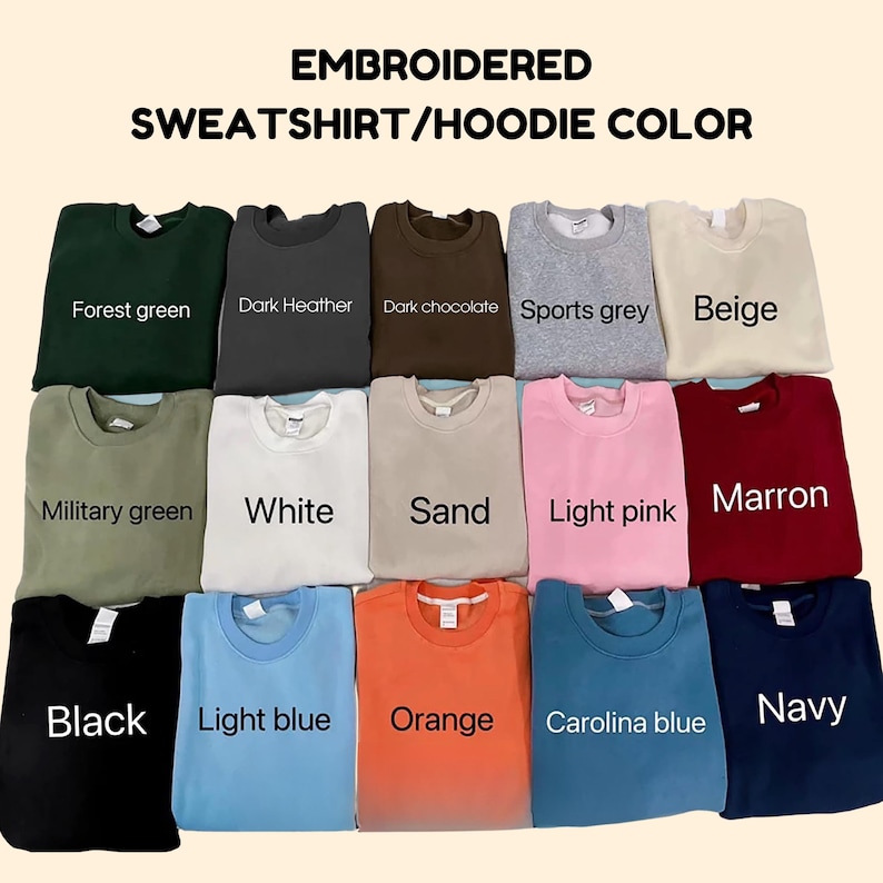 May include: A color chart displaying fifteen crewneck sweatshirts in various shades including forest green, dark heather, dark chocolate, sports grey, beige, military green, white, sand, light pink, marron, black, light blue, orange, carolina blue, and navy.