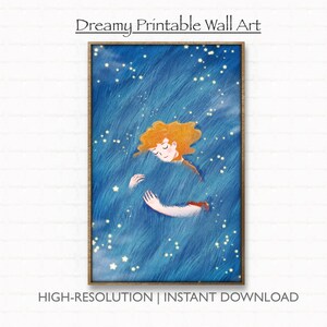 May include: A framed print with a dreamy illustration of a person with orange hair in a blue, textured background with stars. The words "Dreamy Printable Wall Art" and "HIGH-RESOLUTION | INSTANT DOWNLOAD" are printed on the image.