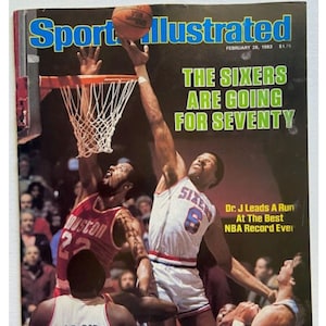 May include: Sports Illustrated magazine cover featuring a basketball game. The cover shows players in action, with one reaching for the ball near the hoop. Text includes "The Sixers Are Going For Seventy" and "Dr. J Leads A Run At The Best NBA Record Ever."