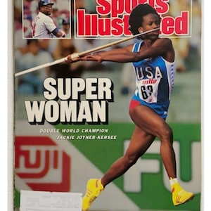 May include: Sports Illustrated magazine cover featuring Jackie Joyner-Kersee, a double world champion, mid-javelin throw. The cover has the text "SUPER WOMAN" in large white letters. The athlete wears a USA uniform with the number 63.