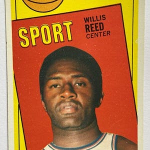 May include: Vintage 1970-71 NBA All-Star trading card featuring Willis Reed, Center. The card has a yellow border with the NBA East logo and the word "SPORT" in bold letters. The background is red.