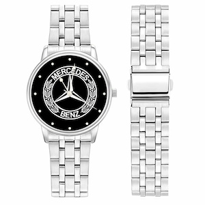 May include: A silver wristwatch with a black face featuring the Mercedes-Benz logo. The watch has a silver band and a separate matching band section. The watch face has white accents and a three-pointed star emblem.