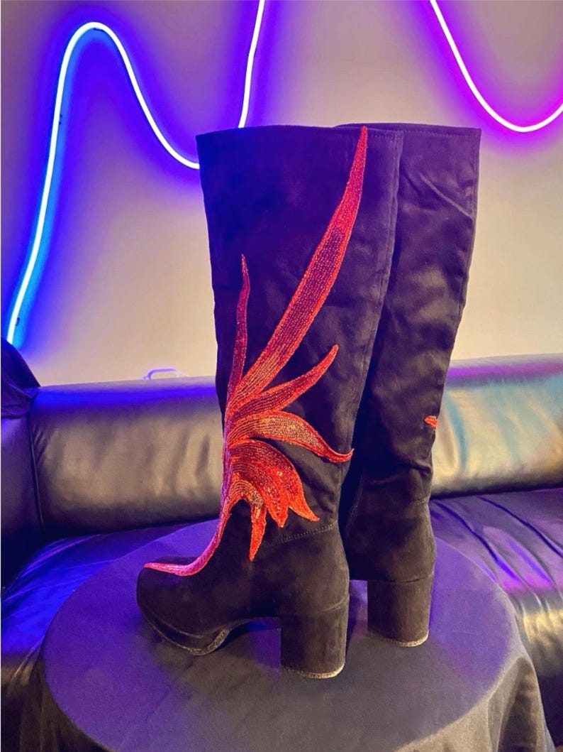 Black faux suede Fireball Flame Boots with red and gold sequin flames designed and created by Niniannebast Designs for Hamilton Fashion Week 2026. Back side view.