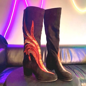 Black faux suede Fireball Flame Boots with red and gold sequin flames designed and created by Niniannebast Designs for Hamilton Fashion Week 2026. Front side view.
