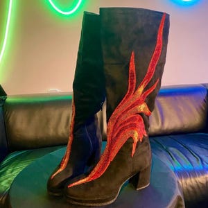 Black faux suede Fireball Flame Boots with red and gold sequin flames designed and created by Niniannebast Designs for Hamilton Fashion Week 2026. Front side view.