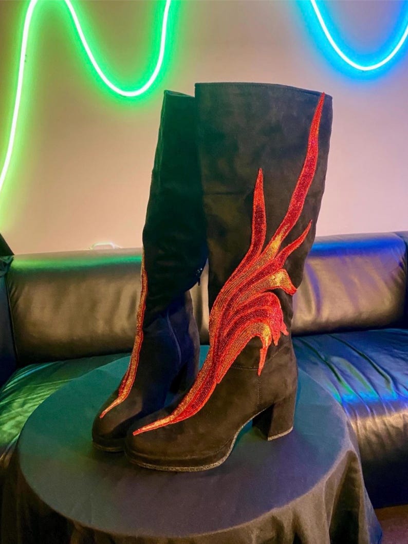 Black faux suede Fireball Flame Boots with red and gold sequin flames designed and created by Niniannebast Designs for Hamilton Fashion Week 2026. Front side view.
