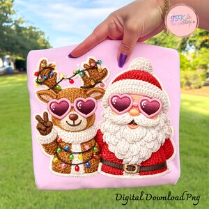 May include: A pink fabric featuring a reindeer and Santa Claus design. The reindeer is brown with heart-shaped sunglasses and a peace sign. Santa Claus wears heart-shaped sunglasses and a red suit. The text "Digital Download Png" is at the bottom.