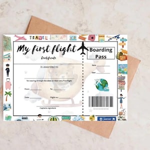 May include: A white "My First Flight" certificate and boarding pass with travel-themed illustrations. The certificate includes space for details and a captain's signature, with a brown envelope in the background.