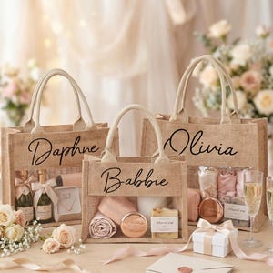 May include: Three burlap tote bags with clear front panels, each personalized with a name in elegant script: "Daphne", "Babbie", and "Olivia". The bags are filled with gifts, including champagne bottles, jewelry, and beauty products. A gift box and champagne flutes are also present.