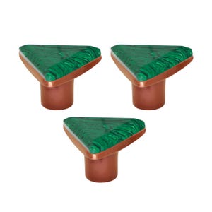 May include: Three cabinet knobs with a triangular green malachite top, copper trim, and a copper base. The knobs are displayed on a white background. Each knob measures approximately 3 cm in height.