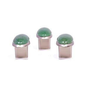 May include: Three cabinet knobs with a green, rounded stone top and a silver-colored metal base. The knobs are displayed against a white background. These decorative knobs can be used for furniture or other home decor projects.