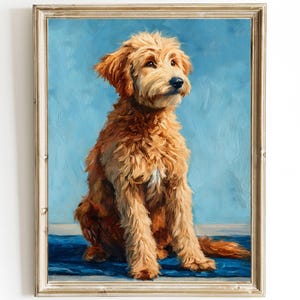 May include: A framed oil painting of a golden doodle dog sitting and looking to the side. The dog has fluffy, light brown fur and is set against a blue background. The painting is in a gold frame.