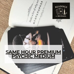 Può includere: Un mazzo di carte dei tarocchi nere ventagliate su un libro aperto. La pagina del libro presenta il testo "Make a list of why not" e un logo con il testo "READINGS BY MICHAEL". Una sovrapposizione bianca mostra il testo "SAME HOUR PREMIUM PSYCHIC MEDIUM".