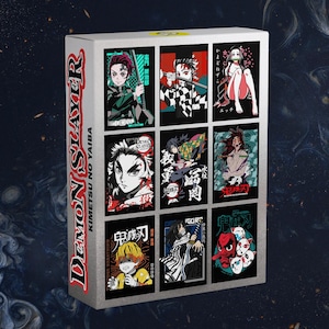 May include: A white box featuring nine colorful illustrations of characters from the anime series "Demon Slayer: Kimetsu no Yaiba." The box has the text "Demon Slayer" and "Kimetsu no Yaiba" printed on the side in red and white.